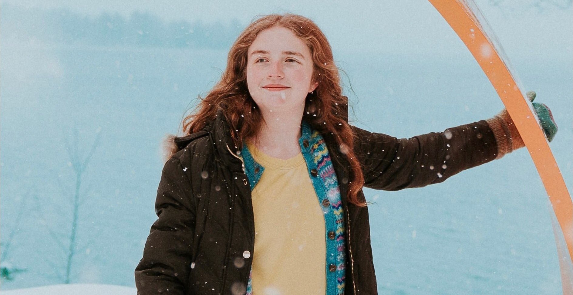 Photo of me leaning on an orange bench.